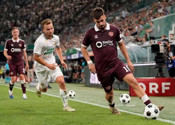 Claudio Braga of Heart of Midlothian in action against Tobias Gulliksen of SK Rapid during a UEFA Conference League Play-Off Second Leg match between SK Rapid and Hearts at Weststadion on August 26, 2026 in Vienna, Austria. Rapid Vienna v Heart of Midlothian, UEFA Conference League, Play-Off Round, Second Leg, Football, Allianz Stadion, Vienna, Austria - 26 Aug 2026Vienna Allianz Stadion Austria  Copyright: xChristianxHofer Shutterstockx 17115048eh