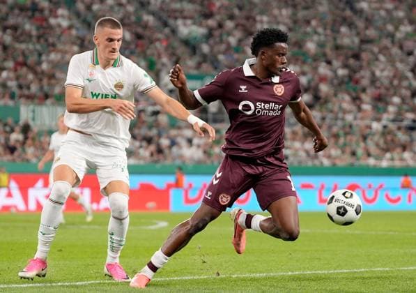 Pierre Landry Kabore of Heart of Midlothian in action against Amin Gröller of SK Rapid during a UEFA Conference League Play-Off Second Leg match between SK Rapid and Hearts at Weststadion on August 26, 2026 in Vienna, Austria. Rapid Vienna v Heart of Midlothian, UEFA Conference League, Play-Off Round, Second Leg, Football, Allianz Stadion, Vienna, Austria - 26 Aug 2026Vienna Allianz Stadion Austria  Copyright: xChristianxHofer Shutterstockx 17115048ei