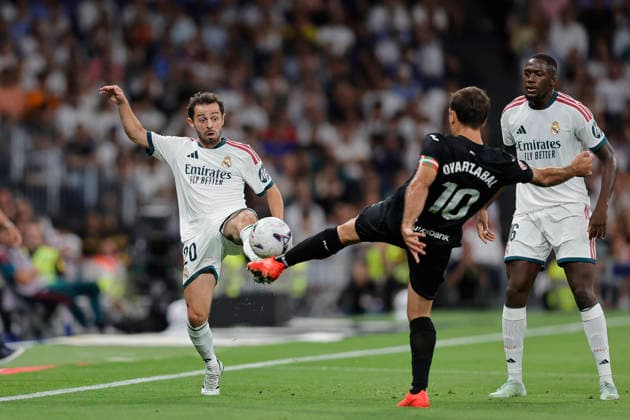 Bernardo Silva of Real Madrid CF and Mikel Oyarzabal of Real Sociedad battle for the ball during the LaLiga EA Sports match between Real Madrid CF and Real Sociedad de Fútbol at Estadio Santiago Bernabéu on August 26, 2026, in Madrid, Spain. Photo by Manu Reino, DeFodi Images