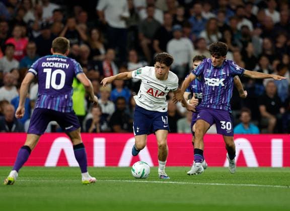 Mikey Moore of Tottenham Hotspur takes on Rob Apter (30) and Greg Docherty (10) of Charlton Athletic Tottenham Hotspur v Charlton Athletic, EFL Carabao Cup, Second Round, Football, Tottenham Hotspur Stadium, London, UK - 26 Aug 2026London Tottenham Hotspur Stadium United Kingdom EDITORIAL USE ONLY No use with unauthorised audio, video, data, fixture lists, club league logos or live services. Online in-match use limited to 120 images, no video emulation. No use in betting, games or single club league player publications.  Copyright: xMattxImpey Shutterstockx 17115050as