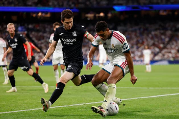 Jude Bellingham of Real Madrid CF and Igor Zubeldia of Real Sociedad battle for the ball during the LaLiga EA Sports match between Real Madrid CF and Real Sociedad de Fútbol at Estadio Santiago Bernabéu on August 26, 2026, in Madrid, Spain. Photo by Manu Reino, DeFodi Images