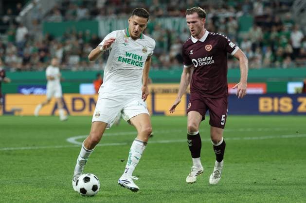 26.August.2026 - SOCCER - 2026 27 UEFA Conference League Play-offs, 2nd Leg, SK Rapid Wien vs Heart of Midlothian FC Ercan Kara (Rapid Wien) and Jamie McCart (Hearts) in one-on-one VIENNA VIENNA, AUSTRIA Allianz Stadion SK Rapid Wien Allianz Stadion AUSTRIA Copyright: xYigitxOermex xPsxImagesxYigitxOermex xPsxImagesx