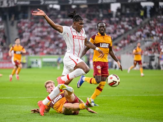 Ewan Wilson of Motherwell FC and Cyriaque Irià of SC Freiburg battle for the ball during the second leg of the 2026-27 UEFA Conference League Playoff Round match between Sport Club Freiburg and Motherwell at Stadion am Wolfswinkel on August 27, 2026 in Freiburg, Germany. Photo by Harry Langer, DeFodi Images