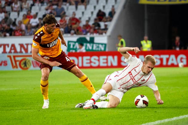 Seb Palmer Houlden of Motherwell FC, 47, and Matthias Ginter of SC Freiburg, 28, in a tackle; Germany, soccer, UEFA Conference League, playoffs, 2026–2027, SC Freiburg vs. Motherwell FC, August 27, 2026, Freiburg im Breisgau, Europa-Park Stadium, Germany Copyright: xGrantxHubbsx