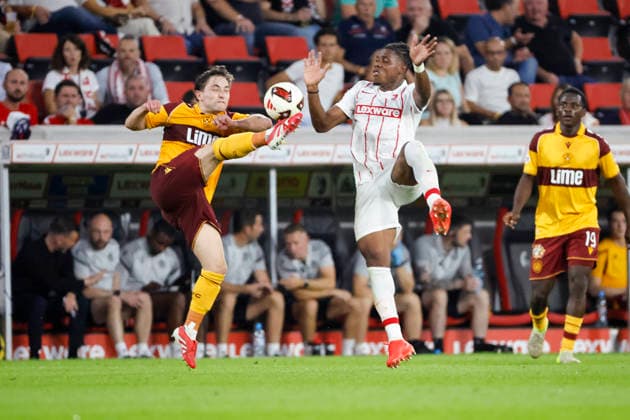 Joe Hodge of Motherwell FC, 71, and Cyriaque Irie of SC Freiburg, 22, in a tackle, Germany, soccer, UEFA Conference League, Playoffs, 2026–2027, SC Freiburg vs. Motherwell FC, August 27, 2026, Freiburg im Breisgau, Europa-Park Stadium, Germany Copyright: xGrantxHubbsx