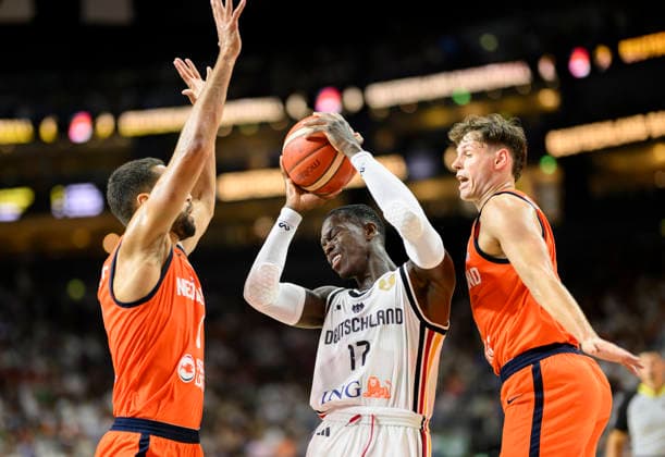 Dennis Schröder of Germany between two players from the Netherlands, in action, Men s Basketball FIBA World Cup Qualifying Game, Second Round Group K, Germany vs. the Netherlands, on August 27, 2026, at the LanxessArena in Cologne, Germany