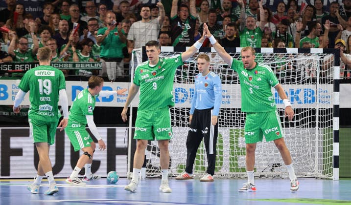 Mathias Gidsel and Frederik Simak high-five Max Darj, with goalkeeper Lasse Ludwig behind them. Handball, HBL Bundesliga Men s Division 1, Matchday, 2026–2027 Season, August 27, 2026: Füchse Berlin vs. MT Melsungen