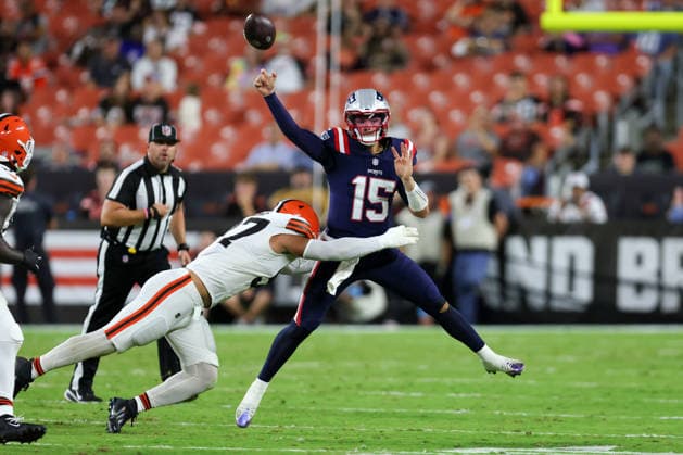 CLEVELAND, OH - AUGUST 27: New England Patriots quarterback Behren Morton (15) throws an interception as he is pressured by Cleveland Browns defensive end Logan Fano (97) during the fourth quarter of the National Football League preseason game between the New England Patriots and Cleveland Browns on August 27, 2026, at Huntington Bank Field in Cleveland, OH. (Photo by Frank Jansky Icon Sportswire) NFL, American Football Herren, USA AUG 27 Patriots at Browns EDITORIAL USE ONLY Icon260827032