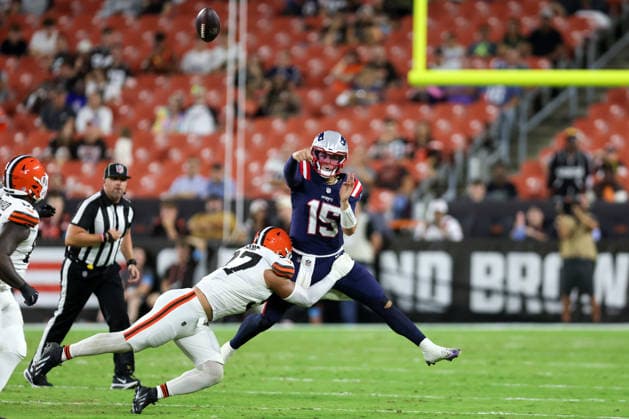 CLEVELAND, OH - AUGUST 27: New England Patriots quarterback Behren Morton (15) throws an interception as he is pressured by Cleveland Browns defensive end Logan Fano (97) during the fourth quarter of the National Football League preseason game between the New England Patriots and Cleveland Browns on August 27, 2026, at Huntington Bank Field in Cleveland, OH. (Photo by Frank Jansky Icon Sportswire) NFL, American Football Herren, USA AUG 27 Patriots at Browns EDITORIAL USE ONLY Icon260827033