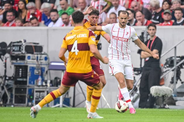 Jamie Knight Lebel of Motherwell FC, Seb Palmer Houlden of Motherwell FC, and Max Rosenfelder of SC Freiburg battle for the ball during the UEFA Conference League 2026–27 Playoff Round Second Leg match between Sport Club Freiburg and Motherwell at Stadion am Wolfswinkel on August 27, 2026 in Freiburg, Germany. Photo by Harry Langer, DeFodi Images
