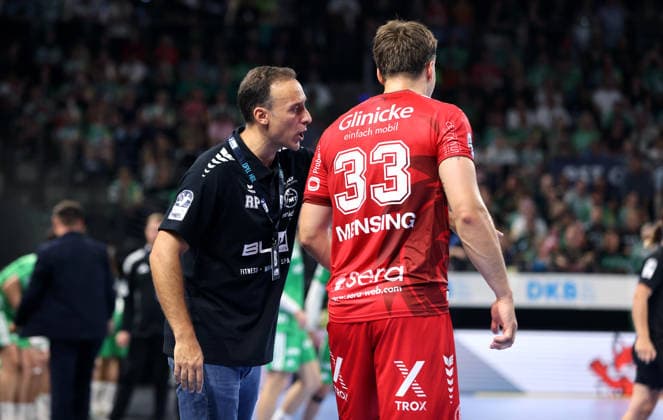 Coach Roberto Garcia Parrondo talks with Aaron Mensing. Upper-body exercise. Handball. HBL Bundesliga Men s Division 1. Matchday. 2026–2027 season. August 27, 2026. Füchse Berlin vs. MT Melsungen