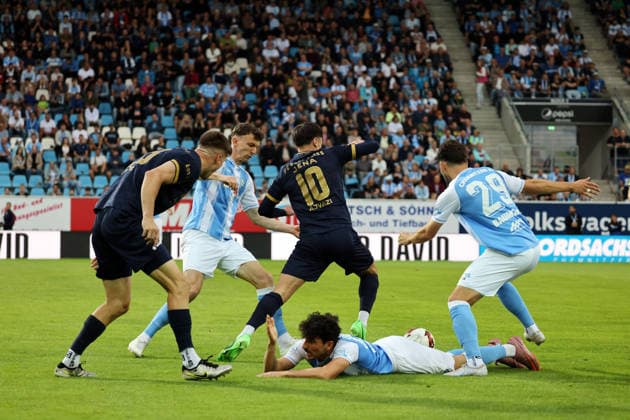 Domenico Alberico 10 is lying on the ground while a Jena player and a Chemnitz player battle for the ball, and Dion Ajazi 10, Tom Baumgart 29, all fighting for the ball; Chemnitzer FC vs. Carl Zeiss Jena, Matchday 7, 2026 Northeast Regional League 27, at the stadium on Gellertstrasse in Chemnitz, Saxony, Germany, August 28, 2026, High-risk match, 1st half