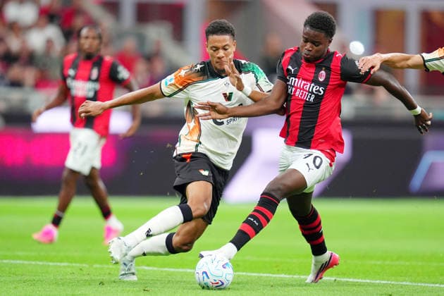 AC Milan™s Alphadjo Cisse fights for the ball with Venezia™s JoÃ«l Schingtienne during the Serie A soccer match between Ac Milan and Venezia at the San Siro Stadium in Milan, north Italy - Friday August 28 , 2026. - Soccer  Copyright: xSpada LaPressex