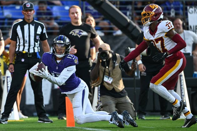 Baltimore Ravens wide receiver Chris Moore (17) catches a pass on the goal line for a touchdown ahead of Washington Commanders cornerback Car lin Vigers (37) during the first quarter of a preseason game at M&T Bank Stadium in Baltimore, Maryland, on Friday, August 28, 2026.  BAL20260828101 DAVIDxTULIS