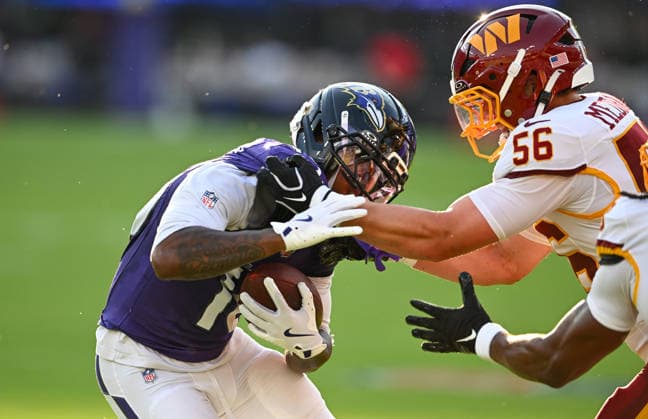Baltimore Ravens wide receiver Lajohntay Wester (10) runs past Washington Commanders linebacker Kain Medrano (56) for a first down during the first quarter of a preseason game at M&T Bank Stadium in Baltimore, Maryland, on Friday, August 28, 2026.  BAL20260828105 DAVIDxTULIS