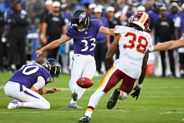 Baltimore Ravens kicker Tyler Loop (33) kicks a 51 yard field goal past Washington Commanders cornerback Fred Davis II during the second quarter of a preseason game at M&T Bank Stadium in Baltimore, Maryland, on Friday, August 28, 2026.  BAL20260828108 DAVIDxTULIS