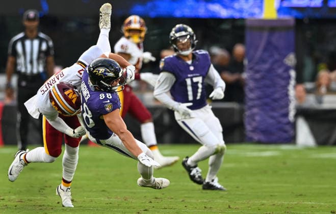 Baltimore Ravens tight end Matt Hibner (88) makes a flying pass reception in front of Washington Commanders linebacker Krys Barnes (47) during the second quarter of a preseason game at M&T Bank Stadium in Baltimore, Maryland, on Friday, August 28, 2026.  BAL20260828112 DAVIDxTULIS