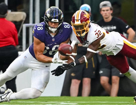 Washington Commanders safety Qwuantrezz Knight (32) blocks an attempted pass to Baltimore Ravens tight end Matt Hibner (88) during the second quarter of a preseason game at M&T Bank Stadium in Baltimore, Maryland, on Friday, August 28, 2026.  BAL20260828113 DAVIDxTULIS