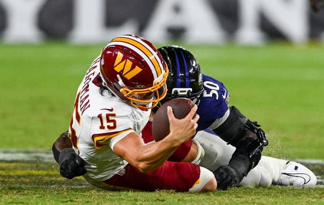 Washington Commanders quarterback Sam Hartman (15) is sacked by Baltimore Ravens linebacker Adisa Isaac (50) on fourth down for a turnover during the fourth quarter of a preseason game at M&T Bank Stadium in Baltimore, Maryland, on Friday, August 28, 2026. The Ravens won 41-3.  BAL20260828115 DAVIDxTULIS
