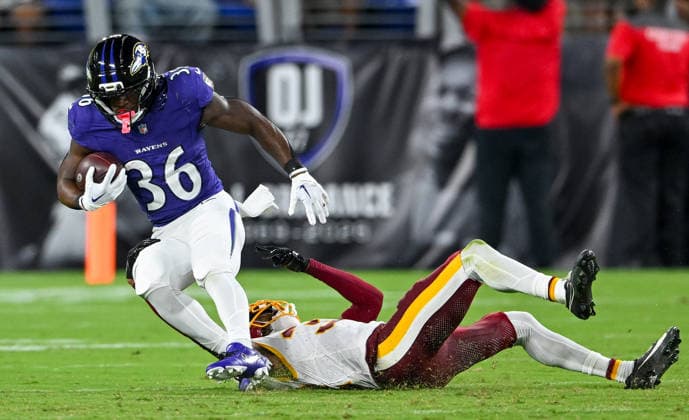 Baltimore Ravens running back Dontae McMillan (36) is tackled by Washington Commanders safety Will Harris (3) after a long run during the fourth quarter of a preseason game at M&T Bank Stadium in Baltimore, Maryland, on Friday, August 28, 2026. The Ravens won 41-3.  BAL20260828127 DAVIDxTULIS