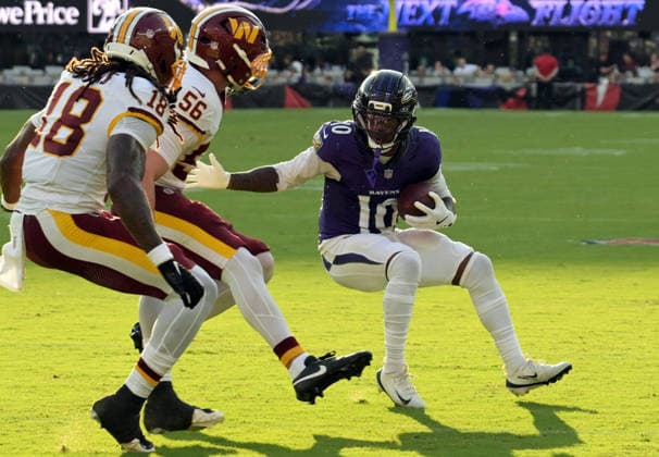 BALTIMORE, MD - AUGUST 28: Baltimore Ravens wide receiver LaJohntay Wester (10) tries to avoid the tackle of Washington Commanders safety Tyler Owens (18) and linebacker Kain Medrano (56) during the preseason NFL, American Football Herren, USA game between the Washington Commanders and the Baltimore Ravens on August 28, 2026, at M&T Bank Stadium in Baltimore, MD. (Photo by Mark Goldman Icon Sportswire) NFL: AUG 28 Commanders at Ravens EDITORIAL USE ONLY Icon74926082808