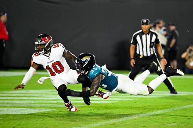 Tampa Bay Quarterback Jalon Daniels is knocked over after throwing an incomplete pass against the Jaguars at EverBank Stadium in Jacksonville, Florida on Friday August 28, 2026. The Jaguars defeated the Bucs 19-0.  JAX20260828016 JOExMARINO