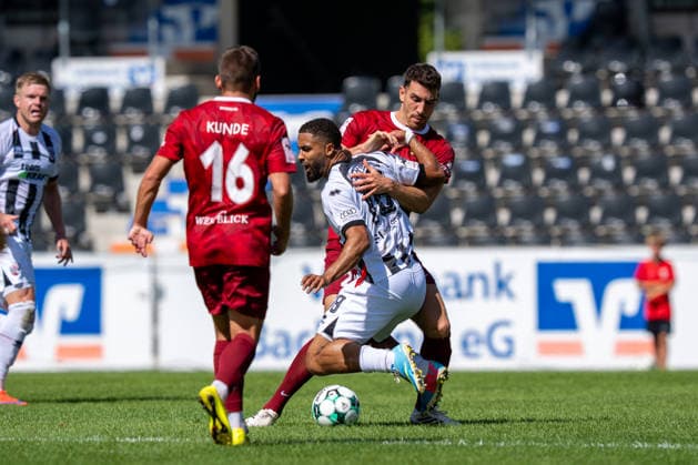 Tackle between Arbnor Nuraj of SG Sonnenhof Großaspach, 25, and Keanan Bennetts of FC Ingolstadt 04, 18, SG Sonnenhof Großaspach vs. FC Ingolstadt 04, Soccer, 3rd Division, Matchday 3, August 29, 2026, DFB regulations prohibit any use of photographs as image sequences and or quasi-video. Aspach, Baden-Württemberg, Germany Copyright: xkolbert-press PhilipxZieglerx
