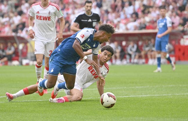 Jahmai Simpson-Pusey r. (1. FC Köln) foult Bambase Conte (1899 Hoffenheim) es gibt Elfmeter, Foul, Aktion, Zweikampf. Fussball 1. Bundesliga, 1.Spieltag, 1. FC Koeln - TSG 1899 Hoffenheim, am 29.08.2026 in Koeln Deutschland. DFL regulations prohibit any use of photographs as image sequences and or quasi-video Â *** Jahmai Simpson Pusey (1. FC Köln) fouls Bambase Conte (1899 Hoffenheim); penalty kick, foul, play, tackle; soccer, Bundesliga, Matchday 1, 1. FC Köln vs. TSG 1899 Hoffenheim, on August 29, 2026, in Cologne, Germany. DFL regulations prohibit any use of photographs as image sequences and or quasi-video.