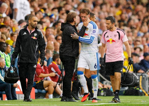 Leeds, England, 30th August 2026. Injured Joe Rodon of Leeds United is consoled by Daniel Farke manager of Leeds United during the Leeds United vs Brentford Premier League match at Elland Road, Leeds. Picture credit should read: James Baylis Sportimage EDITORIAL USE ONLY. No use with unauthorised audio, video, data, fixture lists, club league logos or live services. Online in-match use limited to 120 images, no video emulation. No use in betting, games or single club league player publications. SPI_015_JB_Leeds_Brentford SPI-4950-0016