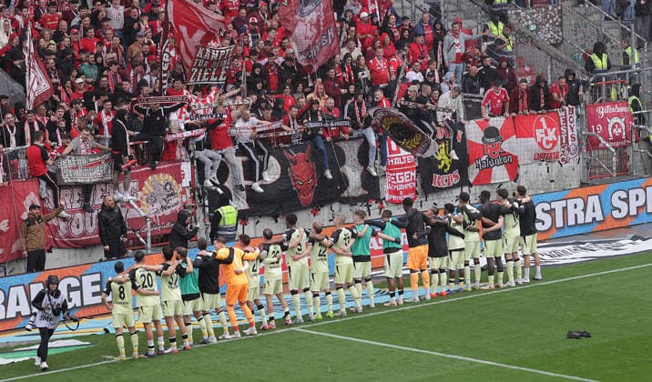 Fans from Kaiserslautern celebrate with their soccer team, 2nd Division, 2026–2027 season, men s division, FC St. Pauli vs. 1. FC Kaiserslautern, 1–2. DFL regulations prohibit any use of photographs as image sequences and or quasi-video.