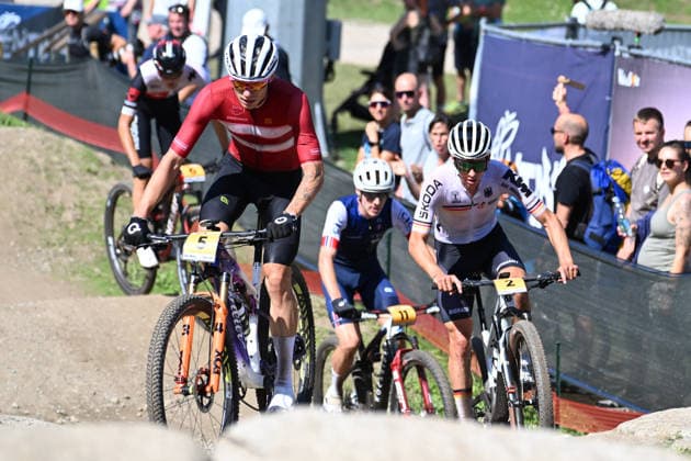 XCO Olympic Cross-Country - Under 23 Men Gustav Pedersen of Denmark, wearing number 5, and Paul Schehl of Germany, wearing number 2, compete during the UCI MTB World Championship, WM, Weltmeisterschaft Val di Sole 2026 XCO Olympic Cross-Country Men Under 23 category race in Val di Sole, Trento, Italy, on August 30, 2026. Commezzadura Trentino Italy  Copyright: xRobertoxTommasinix originalFilename:tommasini-ucimtbwo260830_npPh5.jpg