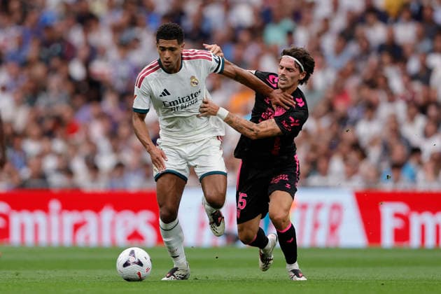 Jude Bellingham of Real Madrid CF and Angel Recio of Málaga CF battle for the ball during the LaLiga EA Sports match between Real Madrid CF and Málaga CF at Estadio Santiago Bernabéu on August 30, 2026, in Madrid, Spain. Photo by Manu Reino, DeFodi Images