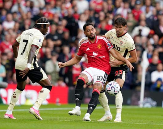 Manchester, England, 30th August 2026. Matheus Cunha of Manchester United, ManU tussles with Sasa Lukic of Ipswich Town during the Manchester United vs Ipswich Town Premier League match at Old Trafford, Manchester. Picture credit should read: Andrew Yates Sportimage EDITORIAL USE ONLY. No use with unauthorised audio, video, data, fixture lists, club league logos or live services. Online in-match use limited to 120 images, no video emulation. No use in betting, games or single club league player publications. SPI_023_AY_Man_Utd_Ipswich SPI-4945-0025