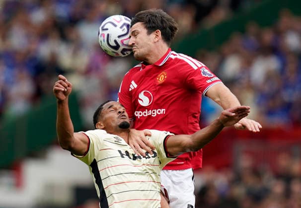 Manchester, England, 30th August 2026. Harry Maguire of Manchester United, ManU challenges Emersonn of Ipswich Town during the Manchester United vs Ipswich Town Premier League match at Old Trafford, Manchester. Picture credit should read: Andrew Yates Sportimage EDITORIAL USE ONLY. No use with unauthorised audio, video, data, fixture lists, club league logos or live services. Online in-match use limited to 120 images, no video emulation. No use in betting, games or single club league player publications. SPI_028_AY_Man_Utd_Ipswich SPI-4945-0028