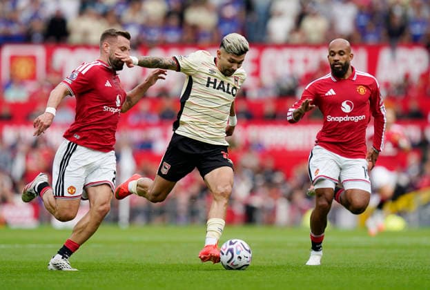 Manchester, England, 30th August 2026. Luke Shaw of Manchester United, ManU catches up with Julio Enciso of Ipswich Town during the Manchester United vs Ipswich Town Premier League match at Old Trafford, Manchester. Picture credit should read: Andrew Yates Sportimage EDITORIAL USE ONLY. No use with unauthorised audio, video, data, fixture lists, club league logos or live services. Online in-match use limited to 120 images, no video emulation. No use in betting, games or single club league player publications. SPI_030_AY_Man_Utd_Ipswich SPI-4945-0030