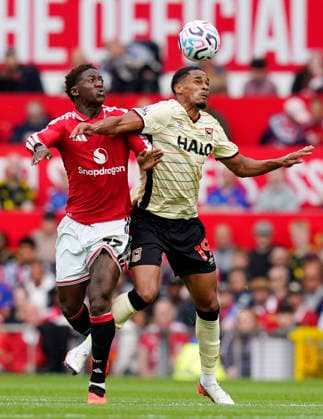 Manchester, England, 30th August 2026. Kobbie Mainoo of Manchester United, ManU challenges Emersonn of Ipswich Town during the Manchester United vs Ipswich Town Premier League match at Old Trafford, Manchester. Picture credit should read: Andrew Yates Sportimage EDITORIAL USE ONLY. No use with unauthorised audio, video, data, fixture lists, club league logos or live services. Online in-match use limited to 120 images, no video emulation. No use in betting, games or single club league player publications. SPI_036_AY_Man_Utd_Ipswich SPI-4945-0036