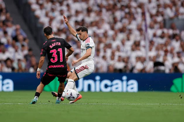 Brahim Diaz of Real Madrid CF and Rafita Garrido of Málaga CF battle for the ball during the LaLiga EA Sports match between Real Madrid CF and Málaga CF at Estadio Santiago Bernabéu on August 30, 2026, in Madrid, Spain. Photo by Manu Reino, DeFodi Images