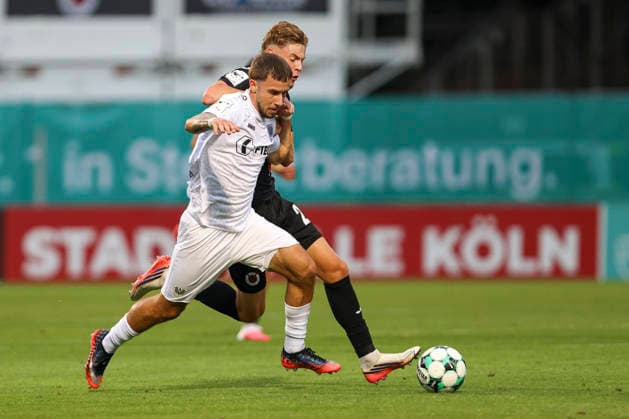 Louis Kolbe of SC Preussen Münster and Niklas Swider of FC Viktoria Köln in a tackle during the 3. Liga match between Viktoria Köln and Preussen Münster at Sportpark Höhenberg on August 30, 2026, in Cologne, Germany. Photo by Oliver Kaelke, DeFodi Images. Louis Kolbe of SC Preussen Muenster and Niklas Swider of FC Viktoria Koeln battle for the ball during the 3. Liga match between Viktoria Koeln and Preussen Muenster at Sportpark Hoehenberg on August 30, 2026 in Cologne, Germany. Photo by Oliver Kaelke, DeFodi Images. DFB and DFL regulations prohibit any use of photographs as image sequences and or quasi-video. Photo by Oliver Kaelke, DeFodi Images.