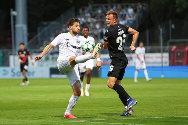 Charalambos Makridis of SC Preussen Münster and Kilian Jakob of FC Viktoria Köln go head-to-head during the 3. Liga match between Viktoria Köln and Preussen Münster at Sportpark Höhenberg on August 30, 2026, in Cologne, Germany. Photo by Oliver Kaelke, DeFodi Images. Charalambos Makridis of SC Preussen Münster and Kilian Jakob of FC Viktoria Köln battle for the ball during the 3. Liga match between Viktoria Köln and Preussen Münster at Sportpark Höhenberg on August 30, 2026 in Cologne, Germany. Photo by Oliver Kaelke, DeFodi Images. DFB and DFL regulations prohibit any use of photographs as image sequences and or quasi-video. Photo by Oliver Kaelke, DeFodi Images.