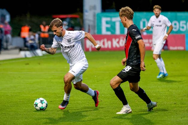 August 30, 2026, xsscx, Soccer 3rd Division, Viktoria Köln vs. Preußen Münster, Matchday 3, Sportpark Höhenberg, 2026–2027 Season: Charalambos Makridis of SC Preußen Münster (No. 14) in a tackle against Tim Kloss of Viktoria Köln (No. 18). DFB regulations prohibit any use of photographs as image sequences and or quasi-video. Photo: xSandraxScherningxPressefotoKochx, North Rhine-Westphalia Germany