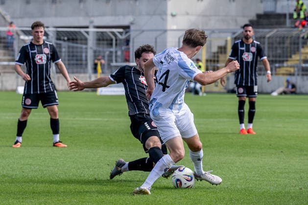 Battle for the Ball: Tackle between Maximilian Holdenrieder (TSV 1882 Landsberg, 14) and Edon Krasniqi (TSV 1860 Munich, 34), GER, TSV 1860 Munich vs. TSV Landsberg 1882, soccer, Bavarian Regional League, Matchday 6, 2026–2027 season, August 30, 2026 DFL DFB REGULATIONS PROHIBIT ANY USE OF PHOTOGRAPHS AS IMAGE SEQUENCES AND OR QUASI-VIDEO Photo: HMB Media, Heike Feiner Copyright: HMBxMedia HeikexFeiner