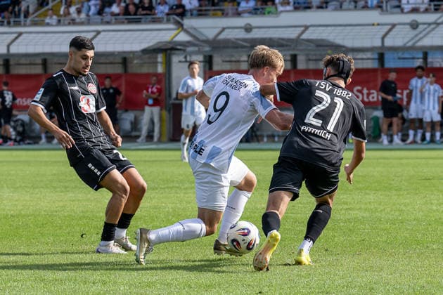 Fabio Wagner of TSV 1860 Munich (No. 09) battles for the ball with Halit Yilmaz of TSV 1882 Landsberg (No. 28) and Kilian Pittrich of TSV 1882 Landsberg (No. 21), GER, TSV 1860 Munich vs. TSV Landsberg 1882, Soccer, Bavarian Regional League, Matchday 6, 2026–2027 Season, August 30, 2026 DFL DFB regulations prohibit any use of photographs as image sequences and or quasi-video. Photo: HMB Media, Heike Feiner Copyright: HMBxMedia HeikexFeiner