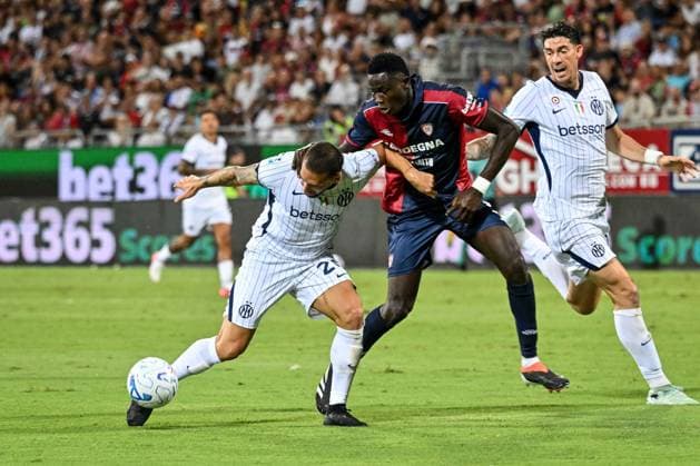 IPA87947454 - Hakan Calhanoglu of Inter and Paul Mendy of Cagliari Calcio during the Cagliari Calcio vs. Inter - FC Internazionale Italian Serie A soccer match in Cagliari, Italy, on August 30, 2026  Copyright: xLuigixCanu IPAxSportx xx 87947454