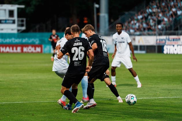 Germany Men s 3rd Division Soccer 2026–2027, Matchday 3: FC Viktoria Köln vs. SC Preußen Münster, Cologne—Charalambos Makridis (SC Preußen Münster), 14, dribbling, attacking, near the penalty area, in a tackle against Kilian Jakob (FC Viktoria Köln), 26, Pascal Armando Fallmann (FC Viktoria Köln), 28, Lucas Mika Wolf (FC Viktoria Köln), 21 Copyright: xThiemoxRudolphx