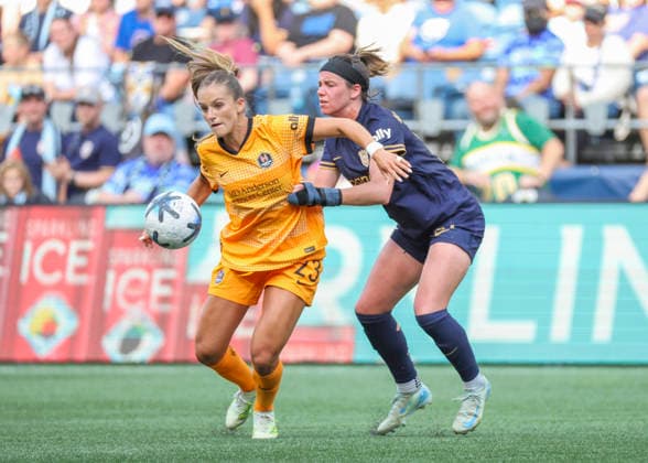SEATTLE, WA - AUGUST 30: (left to right) Houston Dash forward Kate Faasse (23) keeps the ball away from Seattle Reign FC defender Phoebe McClernon (21) in the second half during the NWSL match between the Houston Dash and Seattle Reign FC on August 30, 2026 at Lumen Field in Seattle, Washington. (Photo by Leslie Plaza Johnson Icon Sportswire) SOCCER: AUG 30 NWSL Seattle Reign FC vs Houston Dash EDITORIAL USE ONLY Icon260830030