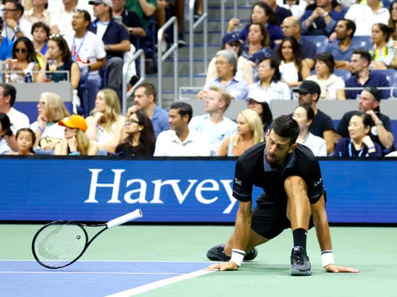 Novak Djokovic of Serbia falls during a point in the 4th set of his match against Mariano Navone of Argentina in Arthur Ashe Stadium in the first round at the 2026 US Open Tennis Championship at the USTA Billie Jean King National Tennis Center in New York City on Sunday, August 30, 2026.  NYP20260830148 JOHNxANGELILLO
