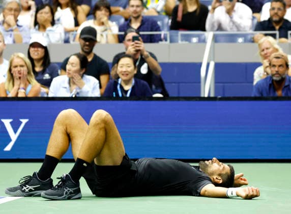 Novak Djokovic of Serbia reacts after he falls to the court during a point in the 4th set of his match against Mariano Navone of Argentina in Arthur Ashe Stadium in the first round at the 2026 US Open Tennis Championship at the USTA Billie Jean King National Tennis Center in New York City on Sunday, August 30, 2026.  NYP20260830149 JOHNxANGELILLO