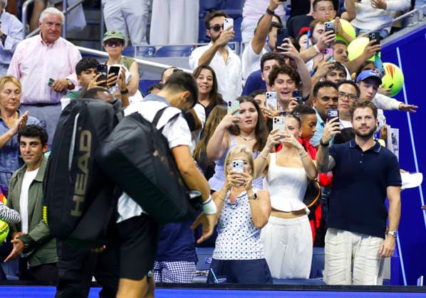 Fans watch Novak Djokovic of Serbia exit the court after his match against Mariano Navone of Argentina in Arthur Ashe Stadium in the first round at the 2026 US Open Tennis Championship at the USTA Billie Jean King National Tennis Center in New York City on Sunday, August 30, 2026. Navone defeated Djokovic in 5 sets.  NYP20260830153 JOHNxANGELILLO