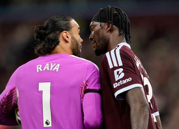 Birmingham, England, 31st August 2026. David Raya of Arsenal and Tammy Abraham of Aston Villa exchange looks during the Aston Villa vs Arsenal Premier League match at Villa Park, Birmingham. Picture credit should read: Andrew Yates Sportimage EDITORIAL USE ONLY. No use with unauthorised audio, video, data, fixture lists, club league logos or live services. Online in-match use limited to 120 images, no video emulation. No use in betting, games or single club league player publications. SPI_059_AY_Villa_Arsenal SPI-4946-0059