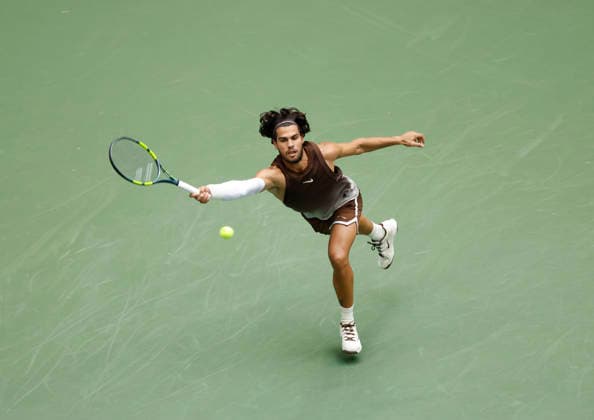 Carlos Alcaraz of Spain returns a ball to Roman Safiullin in Arthur Ashe Stadium at the 2026 US Open Tennis Championship at the USTA Billie Jean King National Tennis Center in New York City on Monday, August 31, 2026. Alcaraz defeated Safiullin in straight sets to advance to the second round.  NYP20260831107 JOHNxANGELILLO